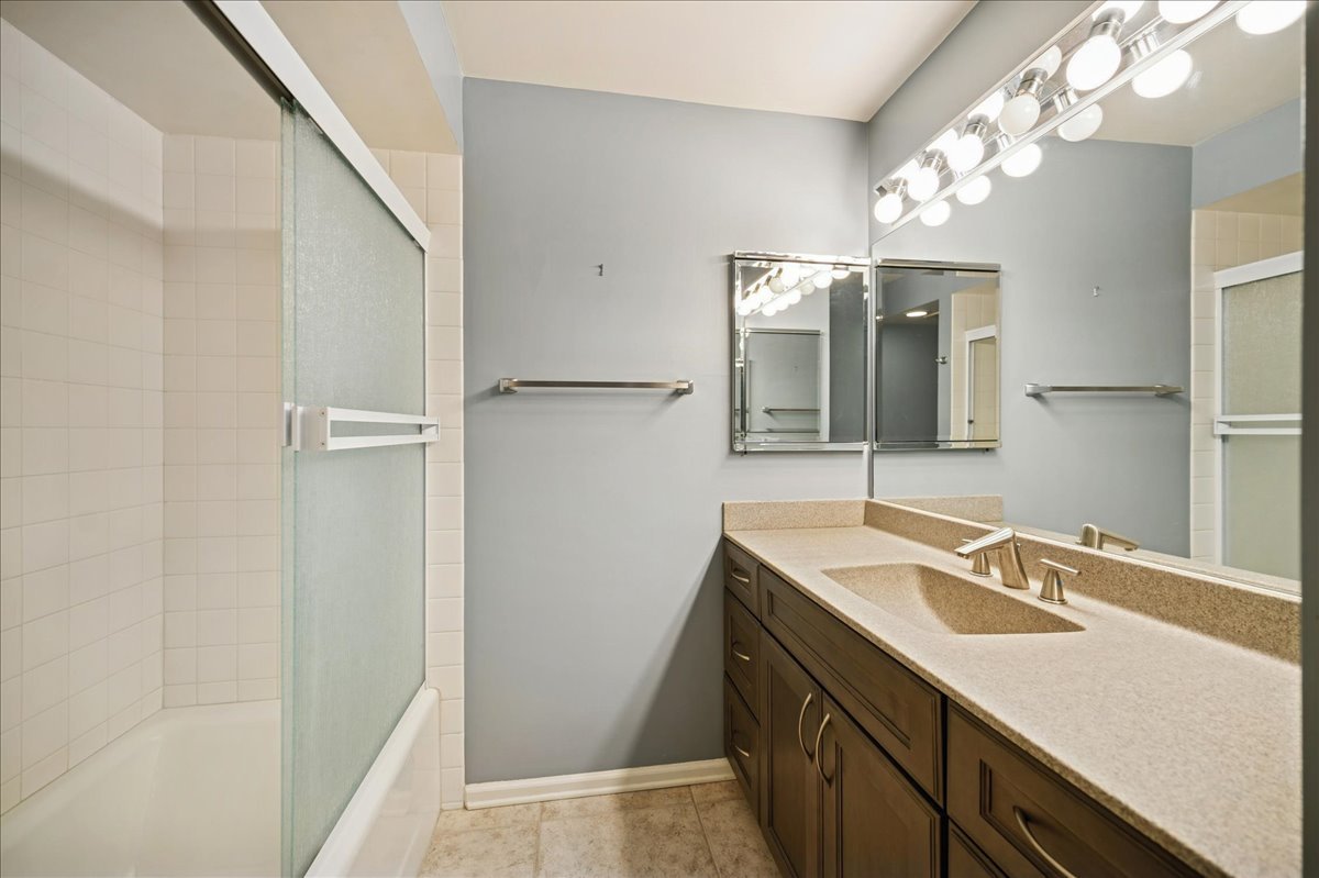 1721 Mission Hills Road, Unit 406 Northbrook, IL 60062 - Photo 20 of 23 a bathroom with a sink vanity granite and a mirror
