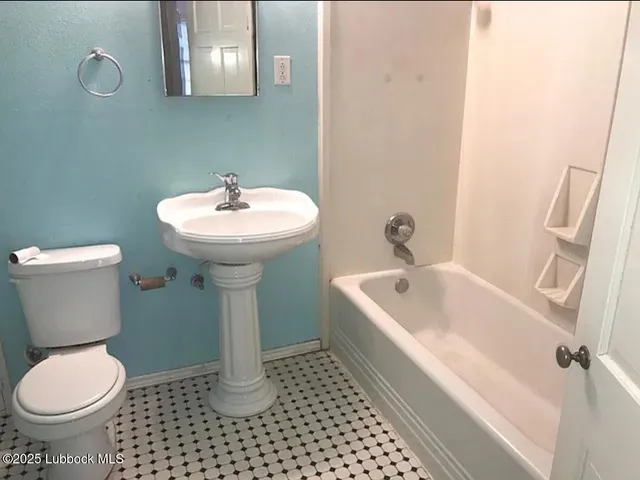 a bathroom with a sink toilet and a bathtub