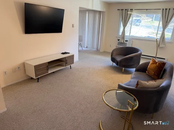 a living room with furniture and a flat screen tv