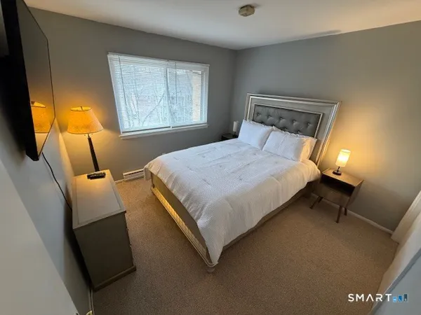 a bedroom with a bed and window