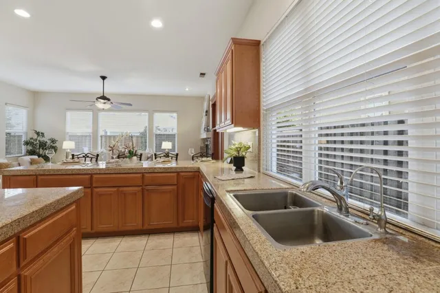a kitchen with a sink cabinets and window