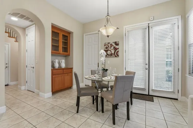 a view of a dining room with furniture and chandelier