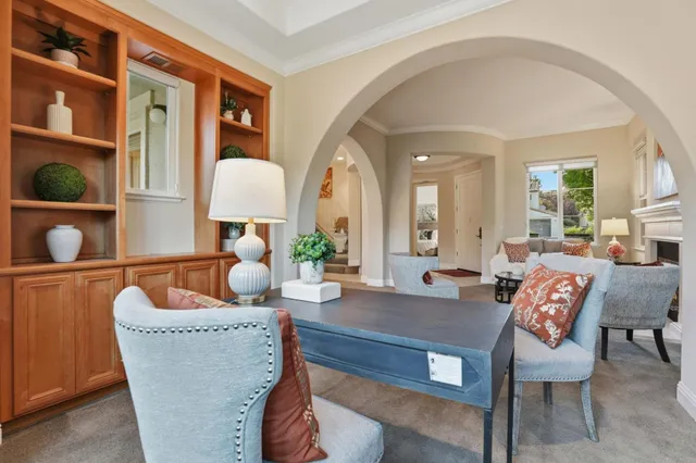 a living room with furniture and a potted plant