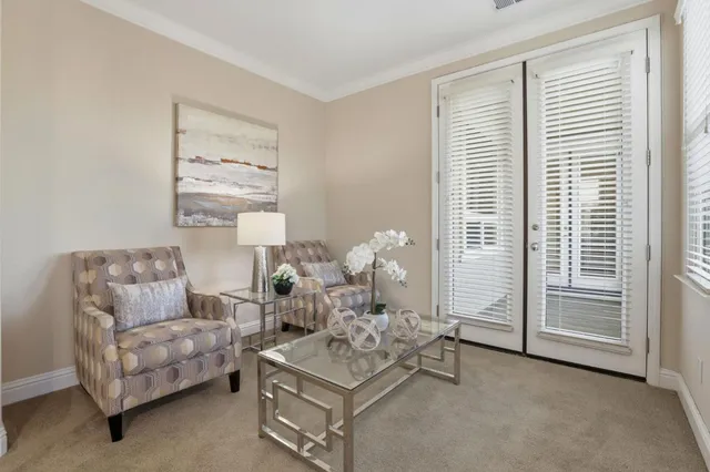 a spacious bedroom with a large bed and a chandelier