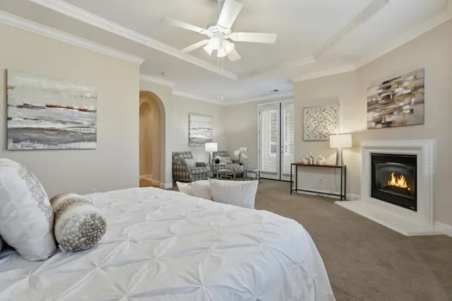 a bedroom with a bed and a potted plant