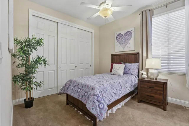 a bedroom with a bed and a painting on the wall