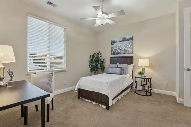 a bedroom with a bed and a chair