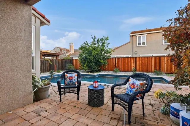 a view of swimming pool with outdoor seating and plants