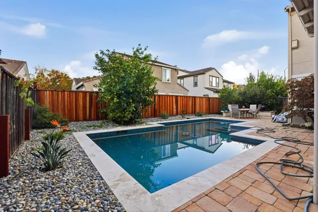 a view of a patio with couches and table and chairs and potted plants
