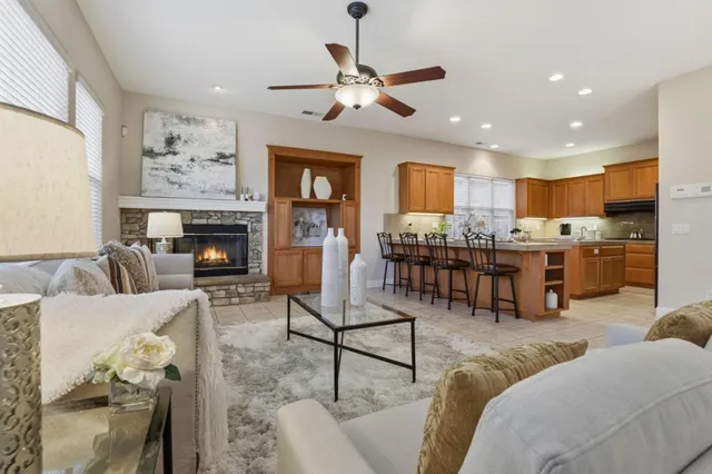 a living room with furniture kitchen view and a fireplace