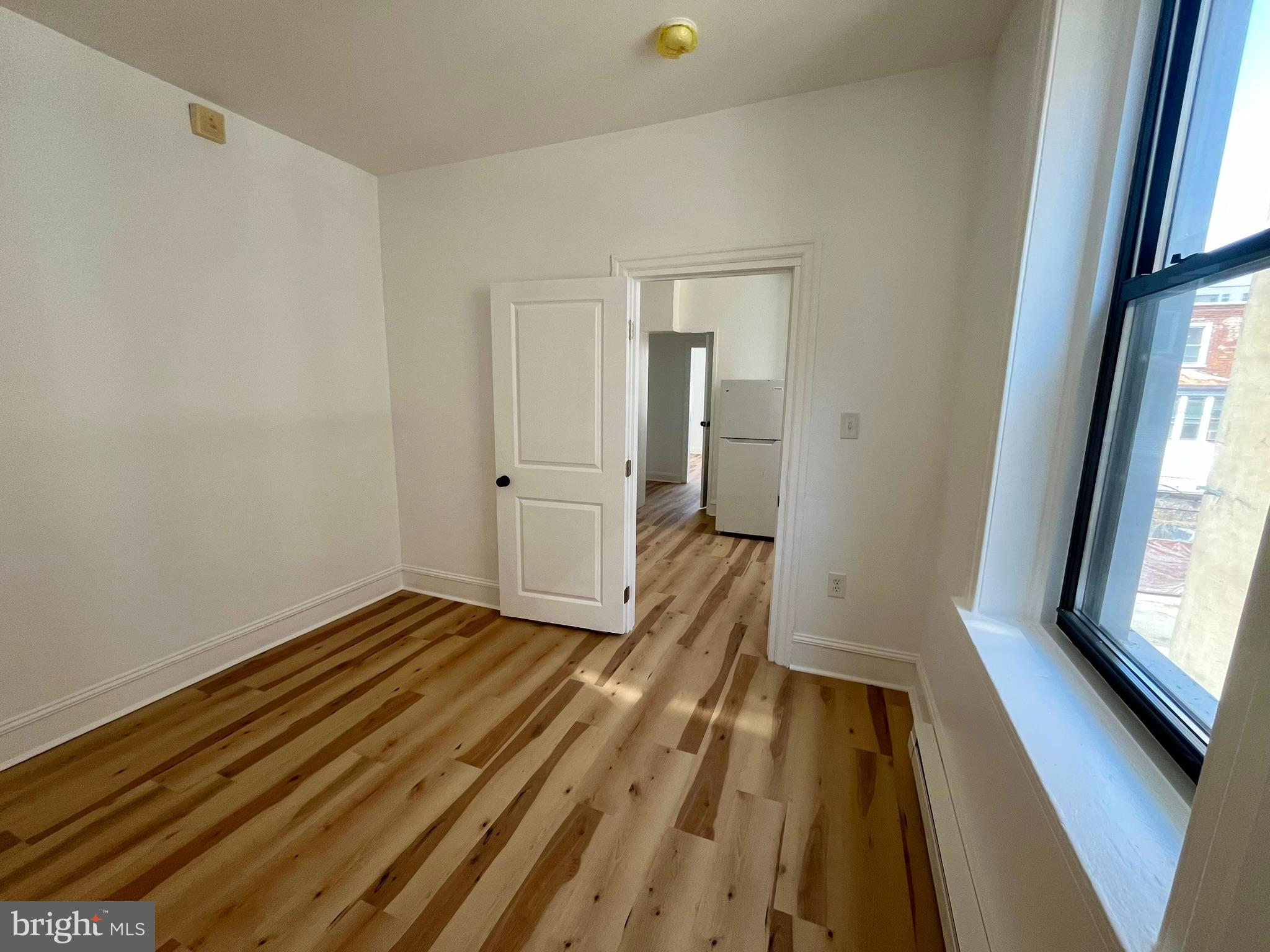 4413 Walnut Street, Unit 2R Philadelphia, PA 19104 - Photo 13 of 18 a view of wooden floor in a room