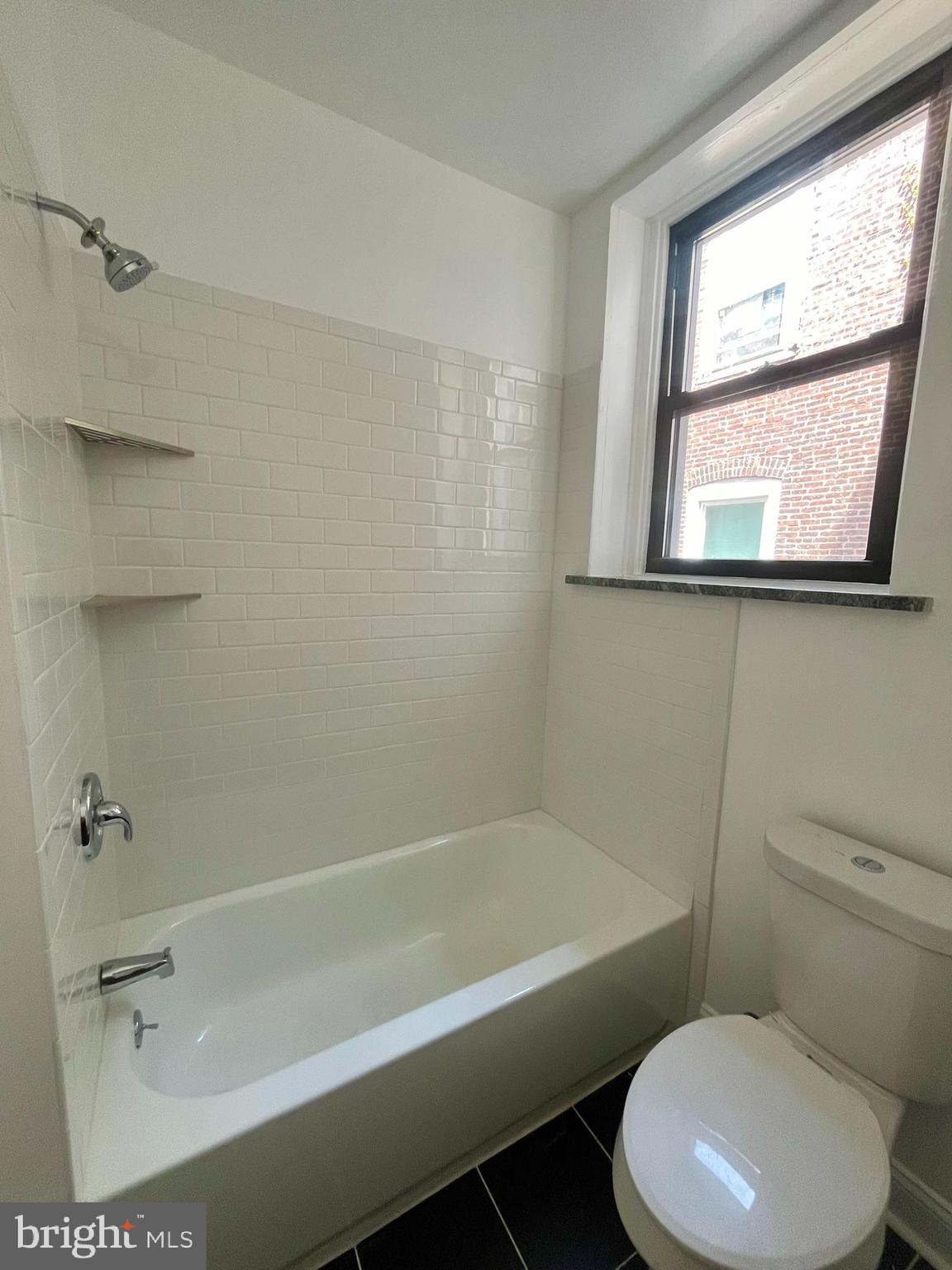 4413 Walnut Street, Unit 2R Philadelphia, PA 19104 - Photo 15 of 18 a bathroom with a toilet bathtub window and shower