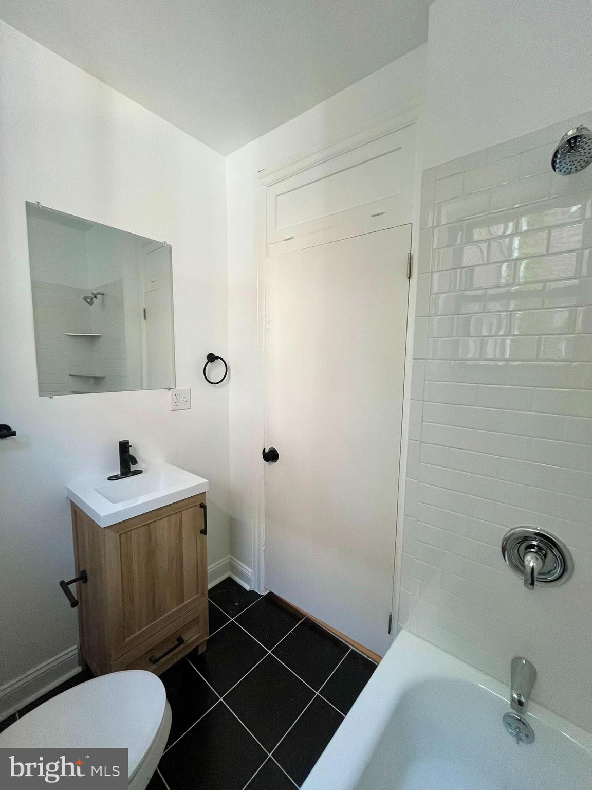 4413 Walnut Street, Unit 2R Philadelphia, PA 19104 - Photo 17 of 18 a bathroom with a sink a toilet a mirror and shower