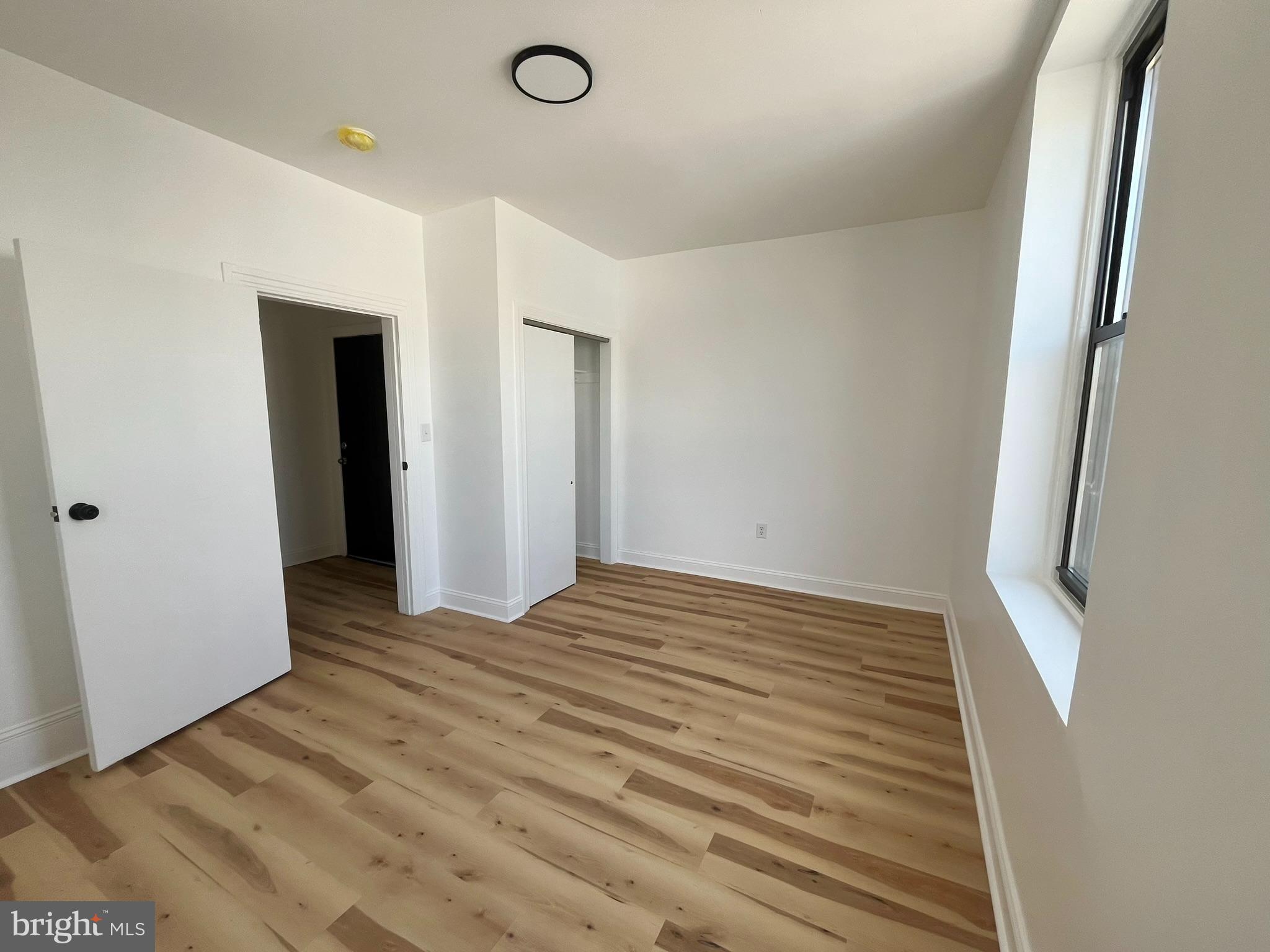 4413 Walnut Street, Unit 2R Philadelphia, PA 19104 - Photo 4 of 18 a view of empty room with wooden floor
