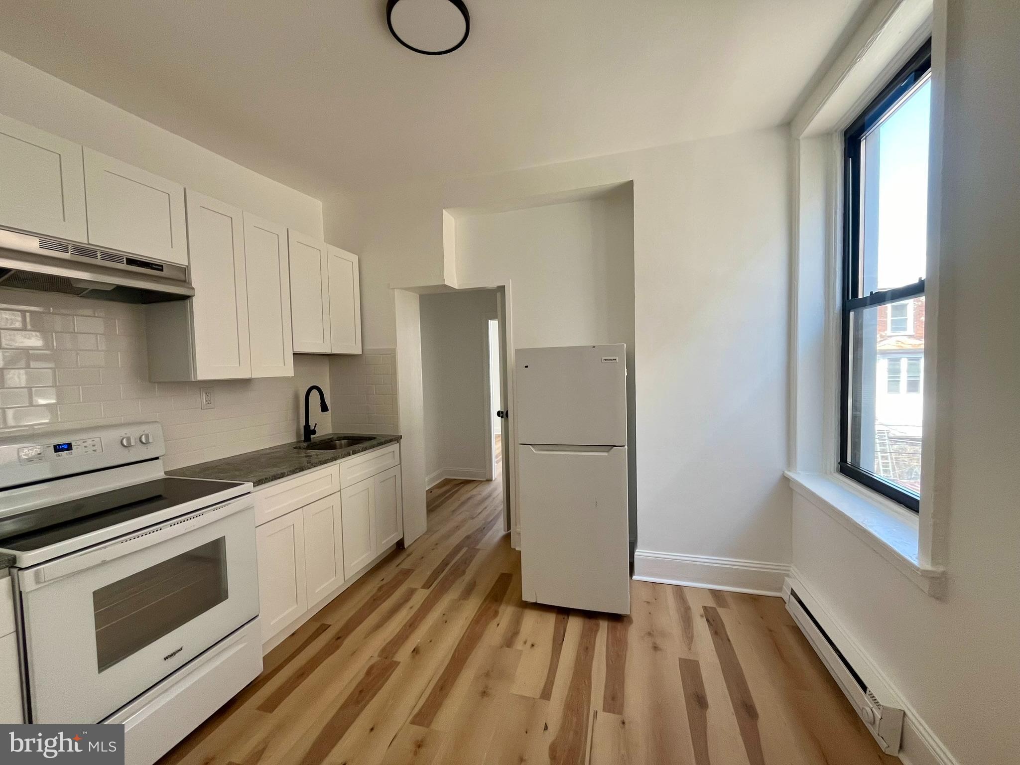 4413 Walnut Street, Unit 2R Philadelphia, PA 19104 - Photo 6 of 18 a kitchen with a sink appliances and cabinets