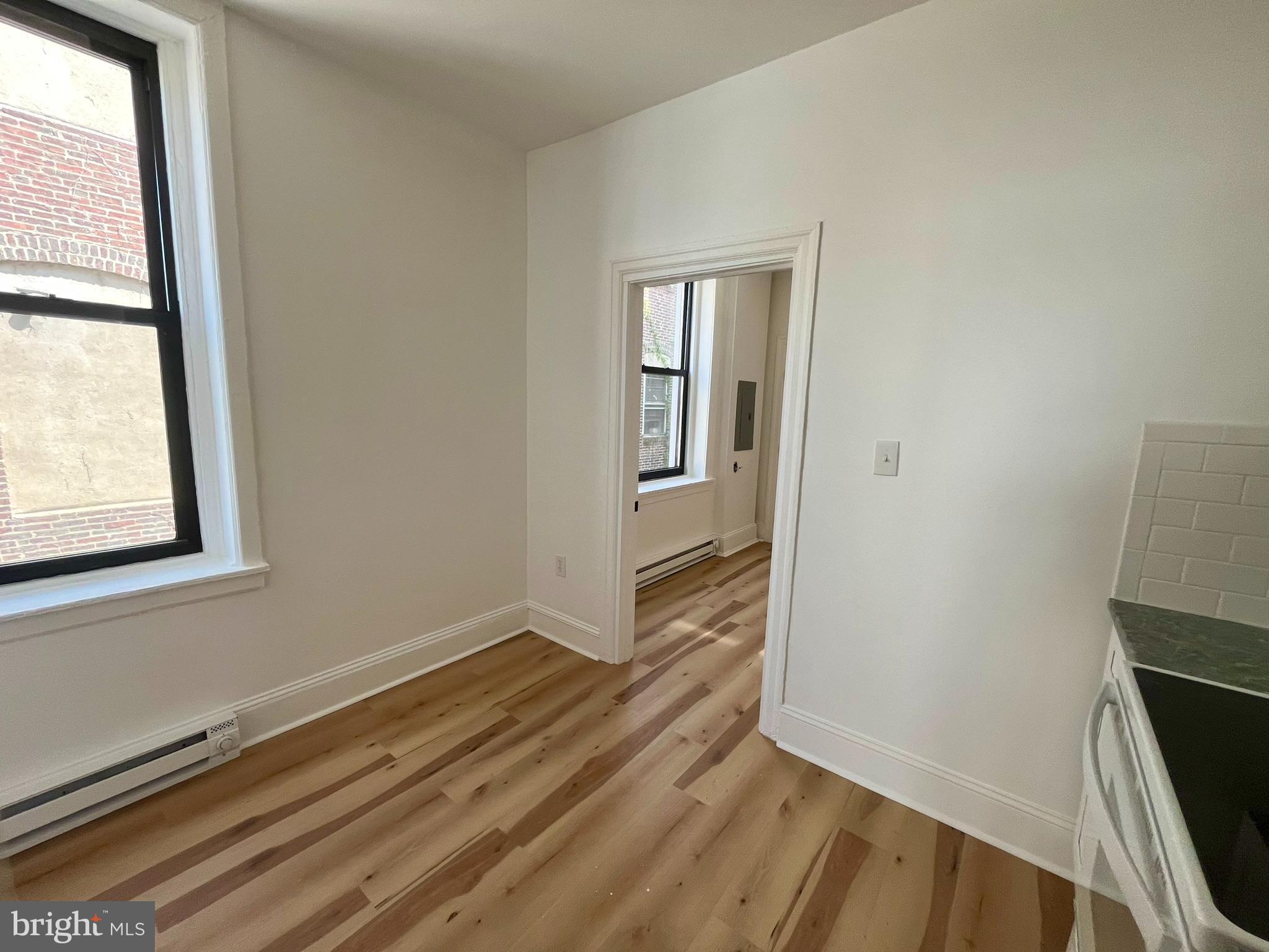 4413 Walnut Street, Unit 2R Philadelphia, PA 19104 - Photo 9 of 18 an empty room with wooden floor and windows