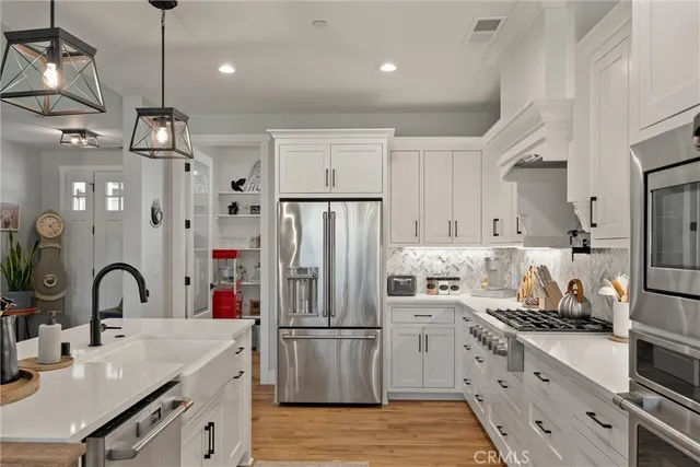 a kitchen with refrigerator a sink and cabinets
