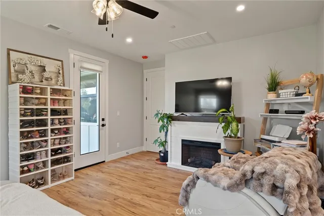 a bedroom with furniture a flat screen tv and a fireplace