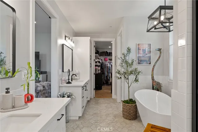 a bathroom with a tub sink and mirror