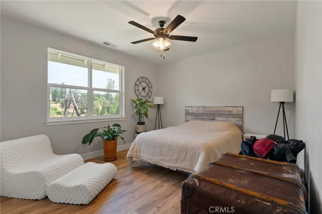 a bedroom with a bed and windows