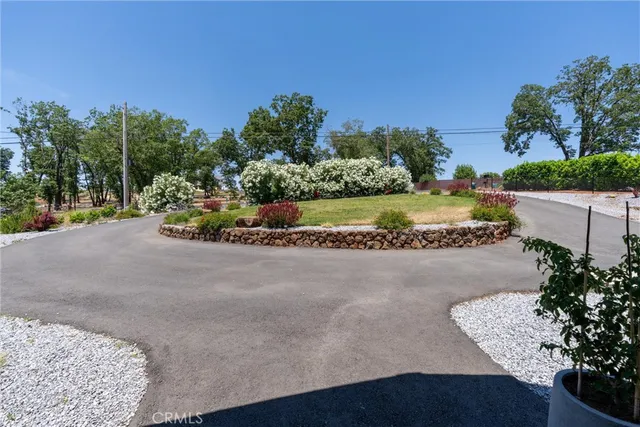an aerial view of a house with a yard and lake view
