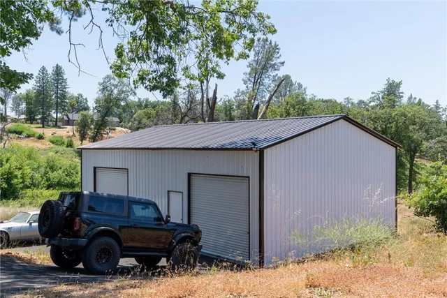 a view of a house that has a bed and a car parked in it