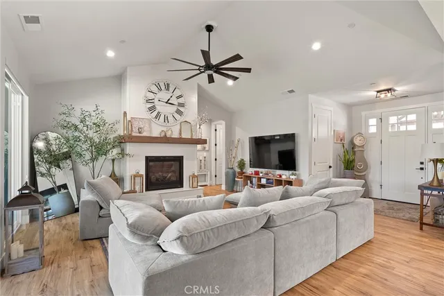 a living room with furniture a fireplace and a flat screen tv