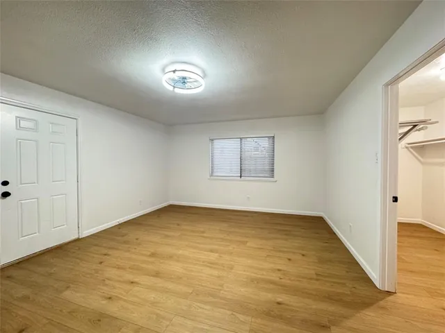 an empty room with a empty space and windows