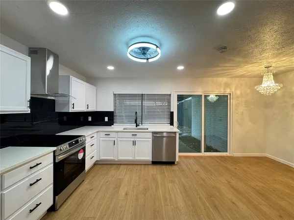 a kitchen with a stove a sink and a refrigerator