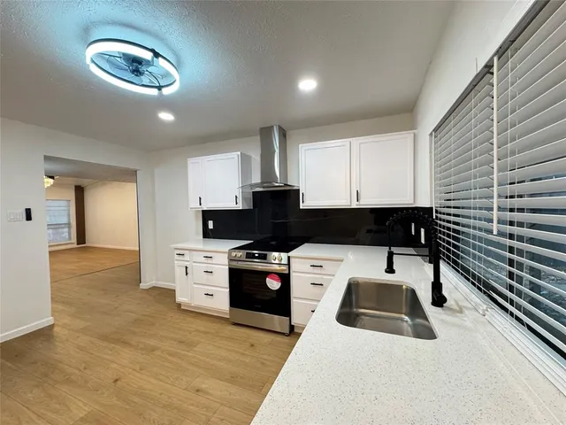 a kitchen with a stove and a sink