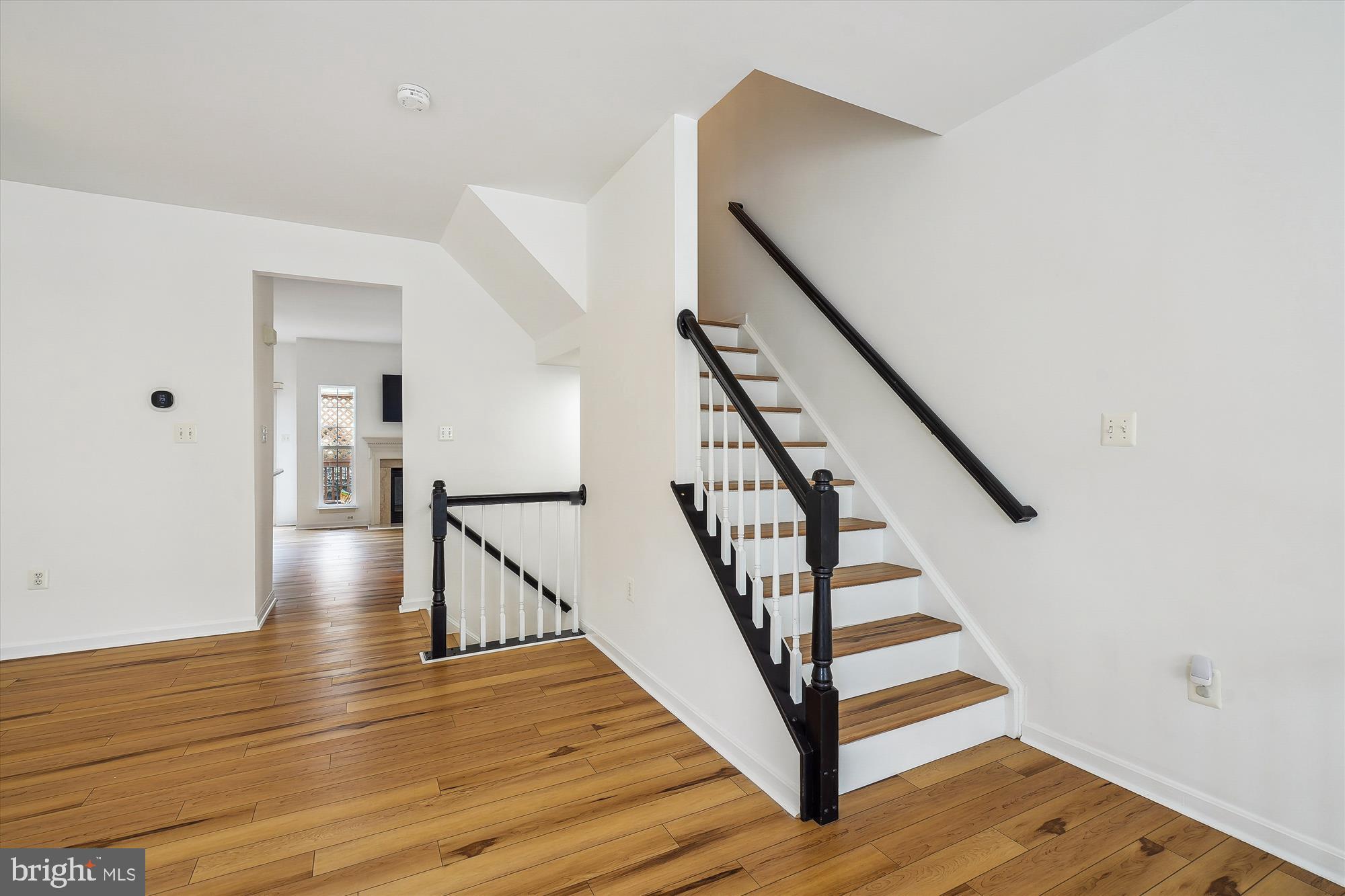 6688 Roderick Loop Gainesville, VA 20155 - Photo 15 of 40 a view of entryway and hall with wooden floor