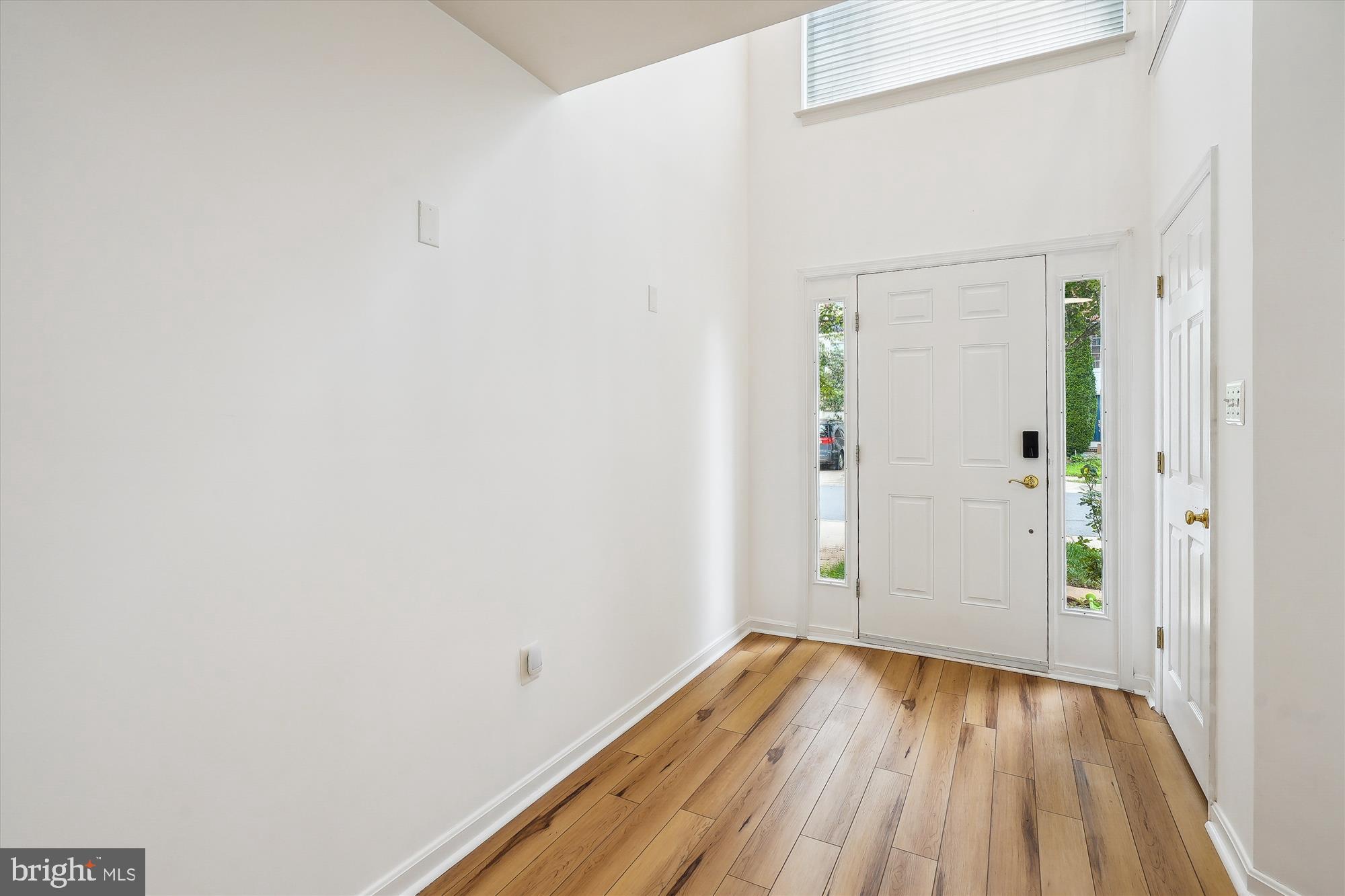 6688 Roderick Loop Gainesville, VA 20155 - Photo 3 of 40 a view of a hallway with wooden floor and closet