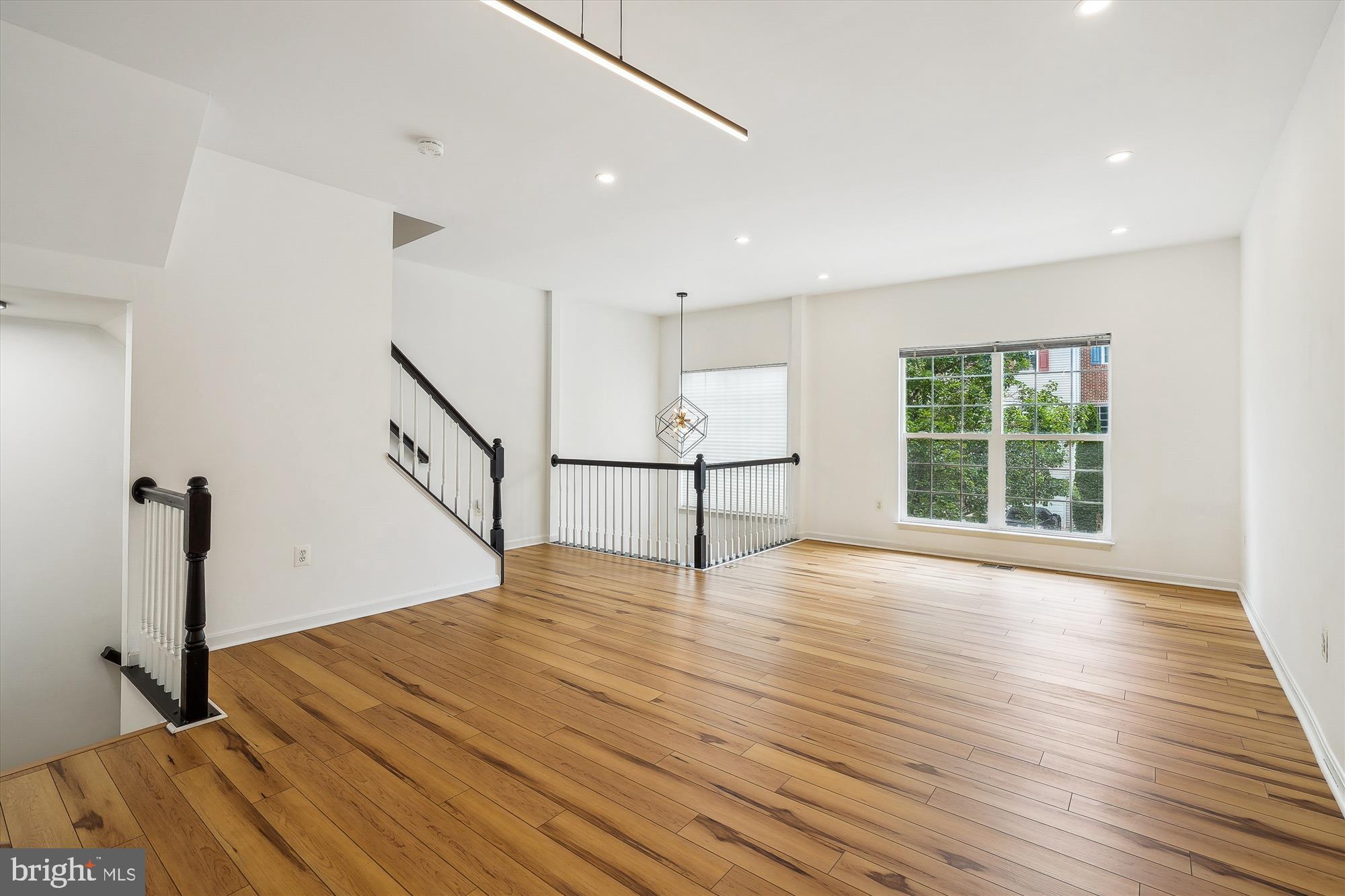 6688 Roderick Loop Gainesville, VA 20155 - Photo 5 of 40 a view of empty room with wooden floor and fan