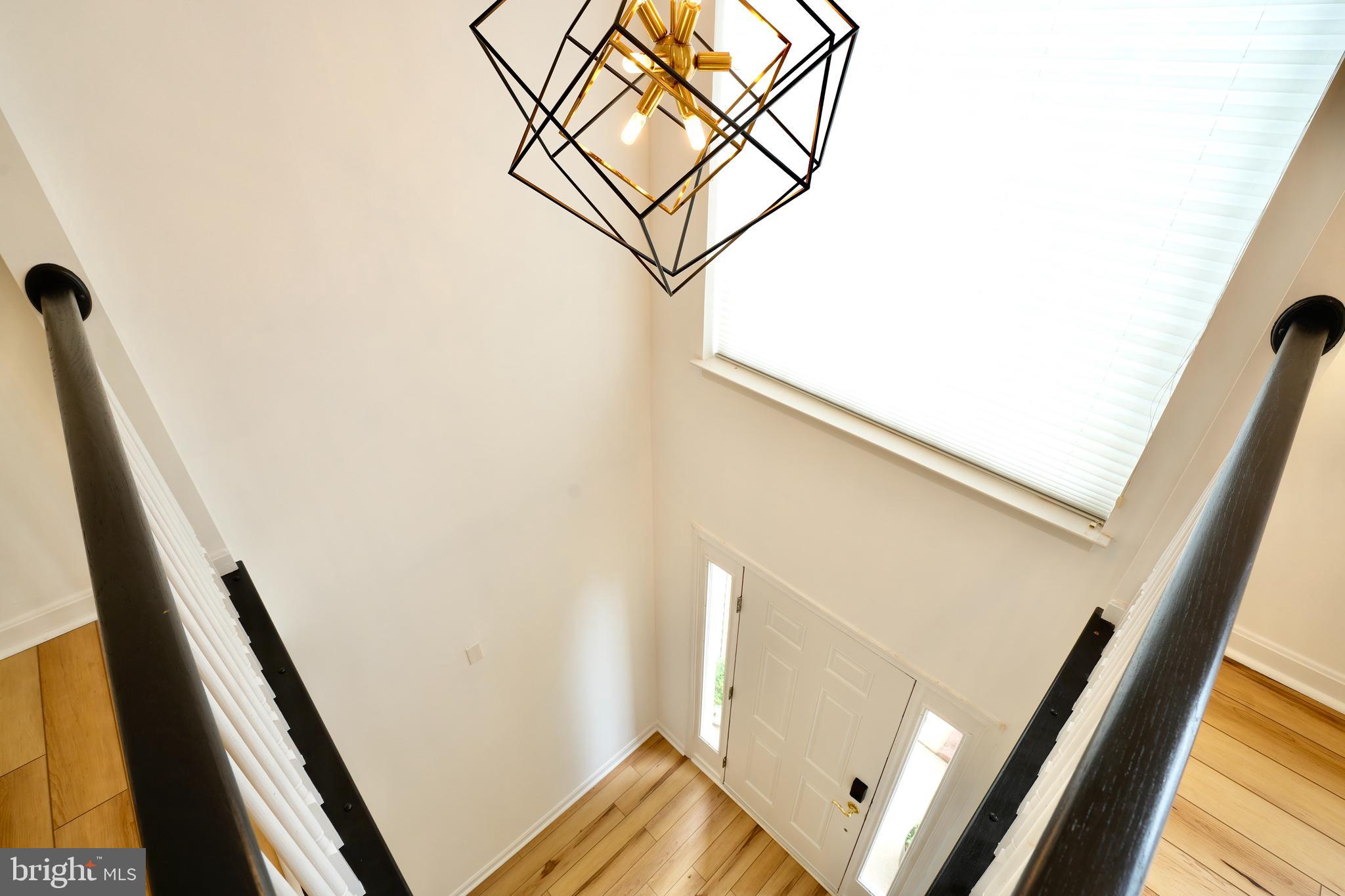 6688 Roderick Loop Gainesville, VA 20155 - Photo 8 of 40 a view of a hallway with wooden floor and staircase