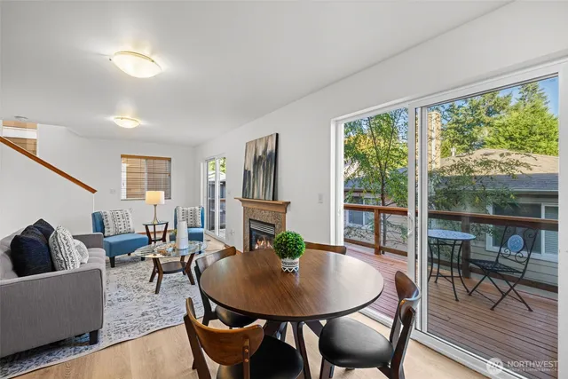 a living room with furniture a table and a large window