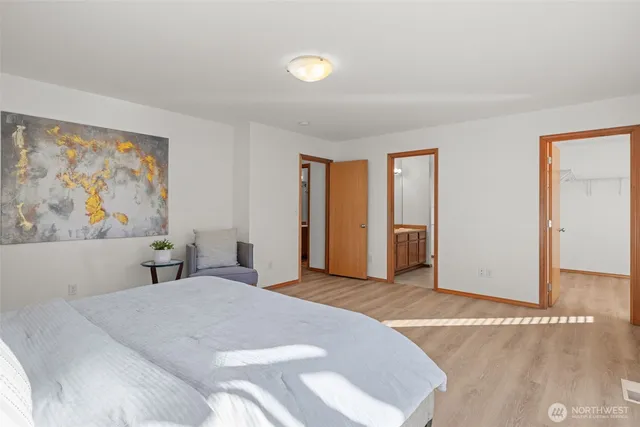 a bedroom with a large bed and a window