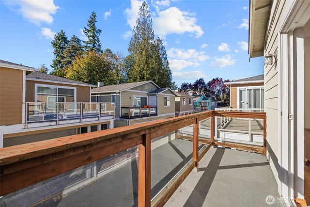 a view of balcony with two chairs and a potted plant