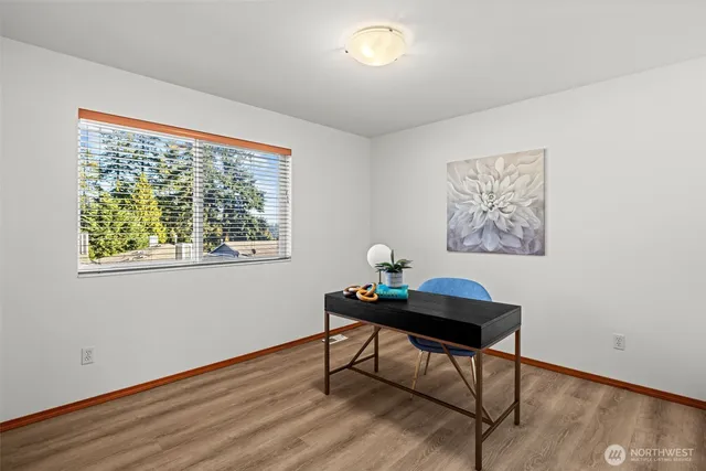 a view of a workspace with furniture and a window