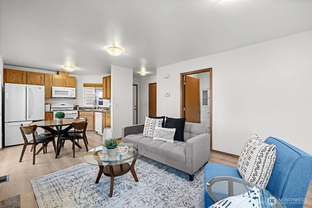 a living room with furniture dining area and a table