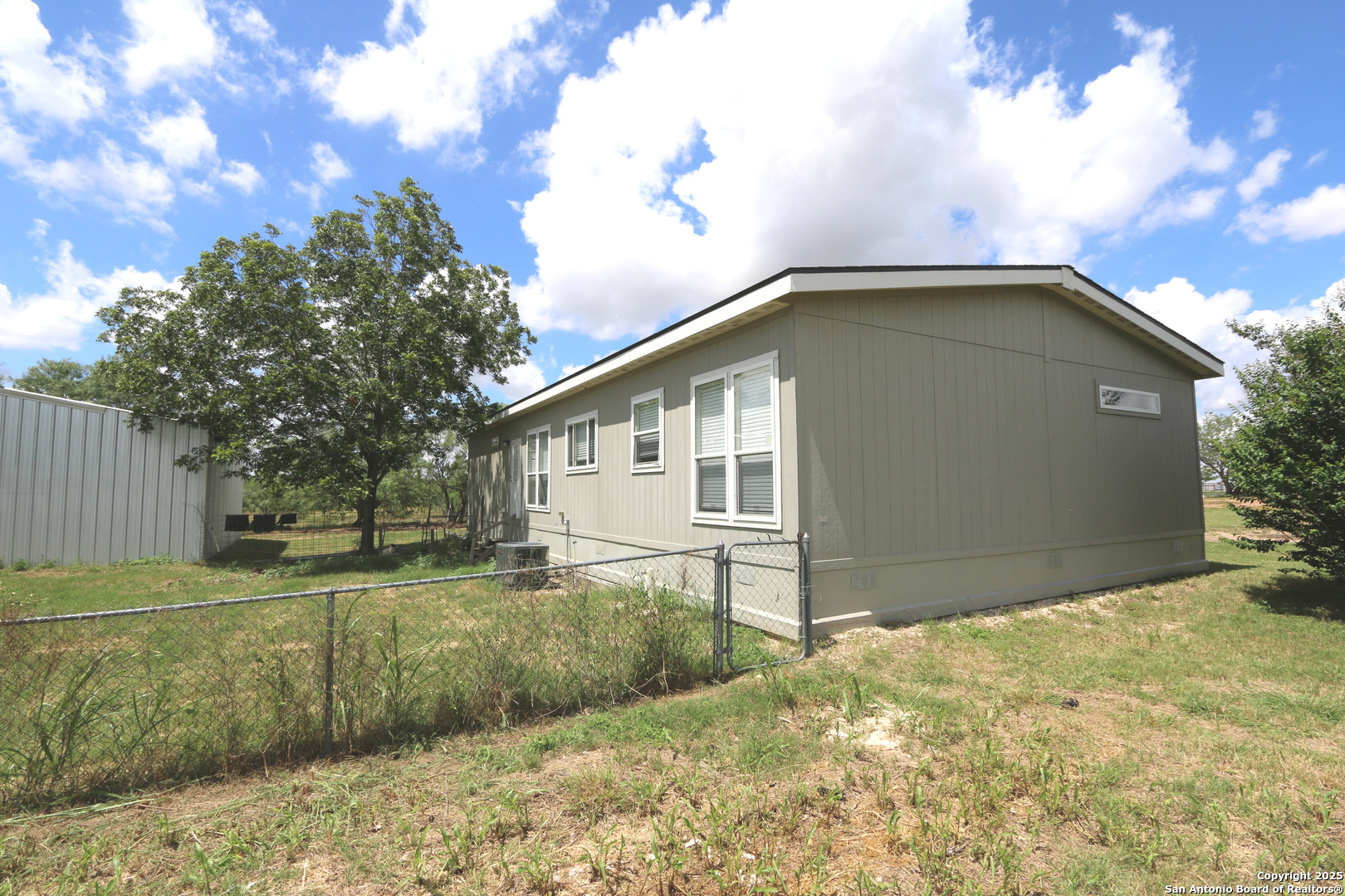 7510 Pittman Road Adkins, TX 78101 - Photo 12 of 42 a backyard of a house with lots of green space