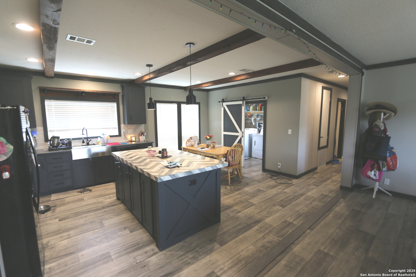 7510 Pittman Road Adkins, TX 78101 - Photo 14 of 42 a kitchen with stainless steel appliances granite countertop wooden cabinets and a sink