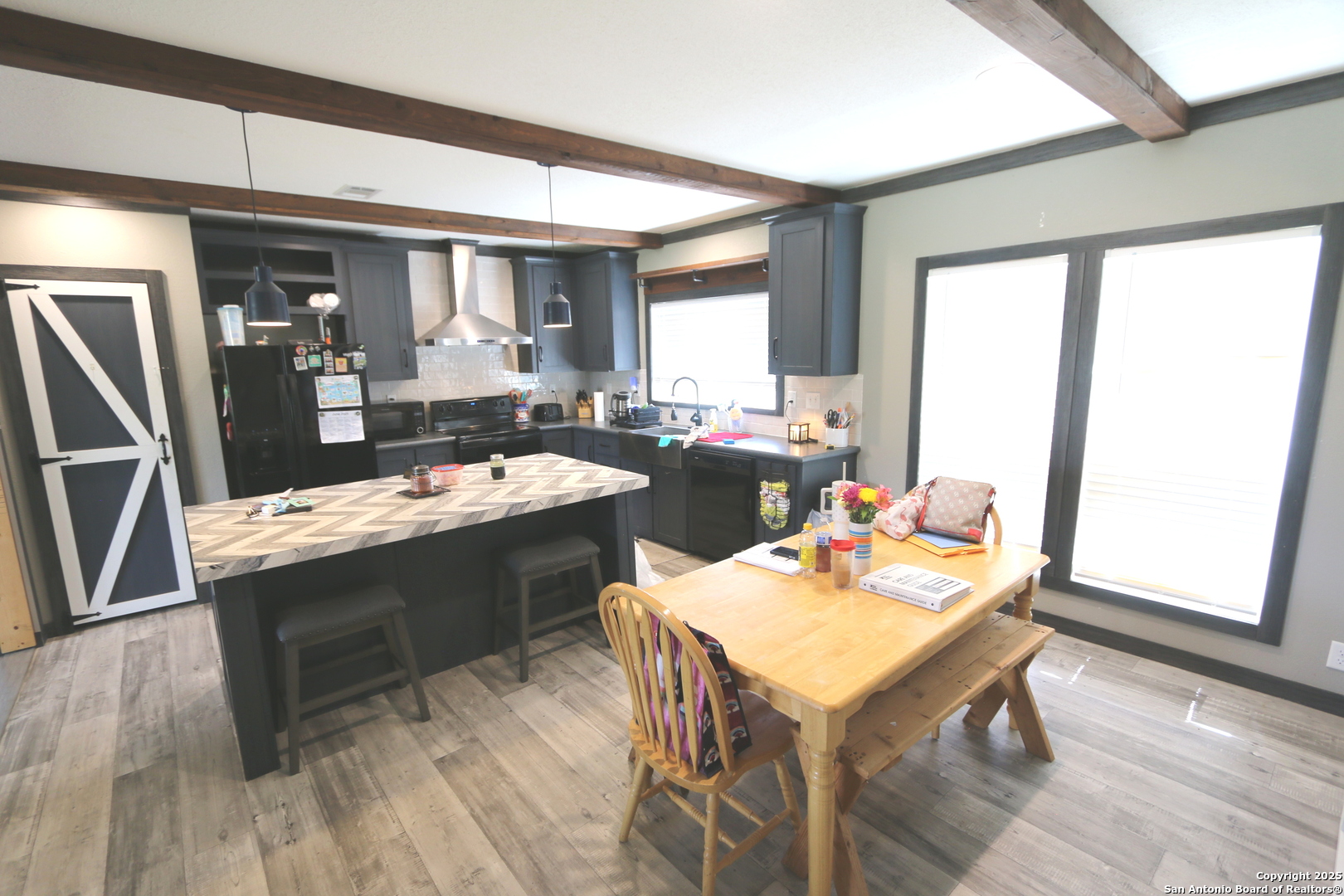 7510 Pittman Road Adkins, TX 78101 - Photo 17 of 42 a kitchen with a table chairs and wooden floor