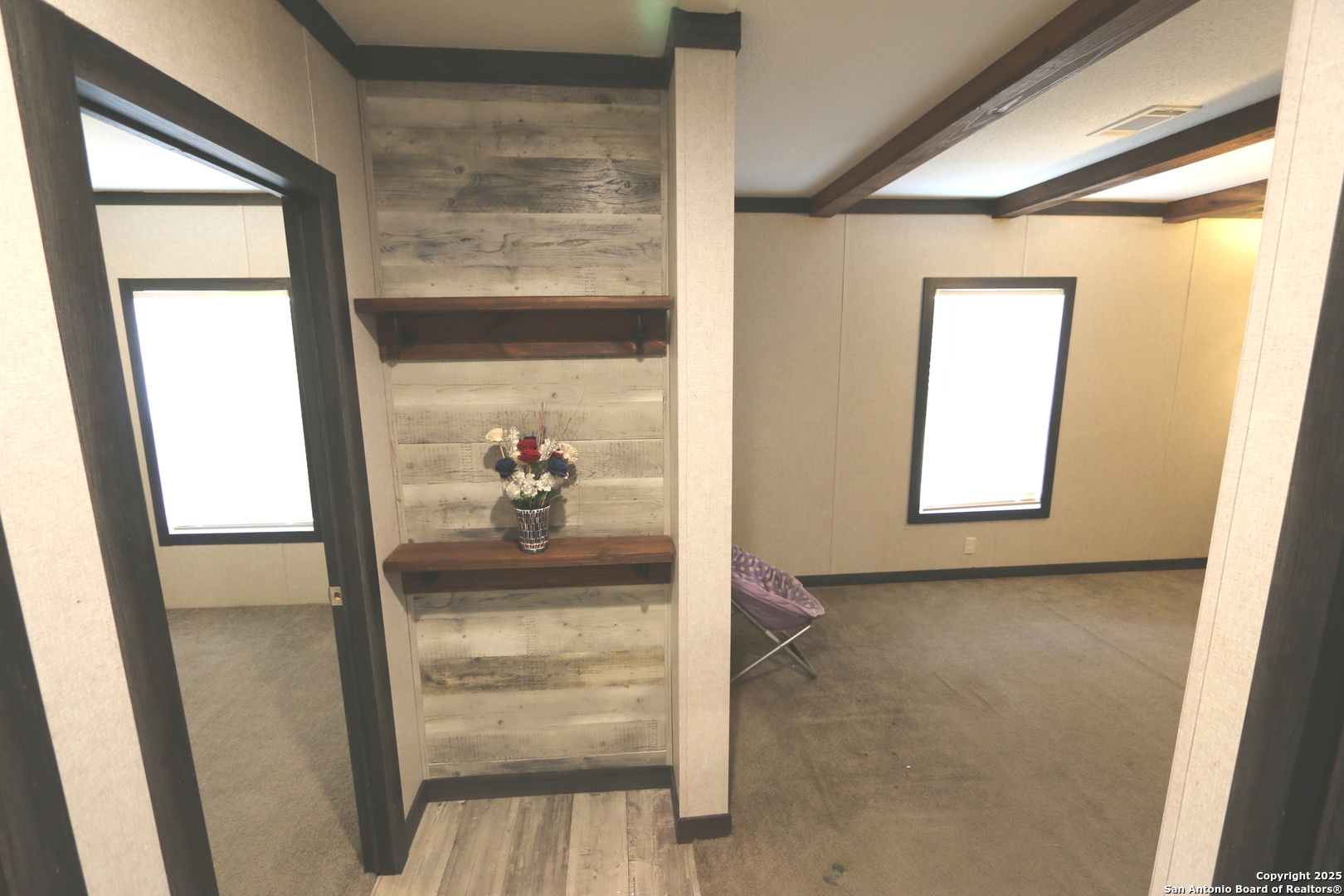 7510 Pittman Road Adkins, TX 78101 - Photo 21 of 42 a view of a hallway with wooden floor and windows