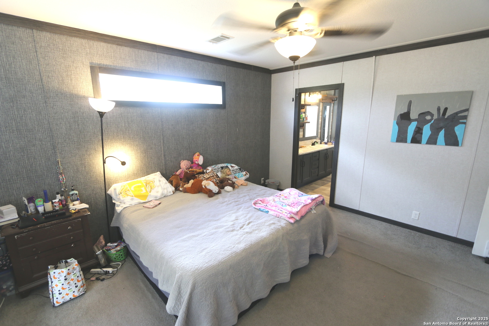 7510 Pittman Road Adkins, TX 78101 - Photo 23 of 42 a bedroom with a bed and a chandelier