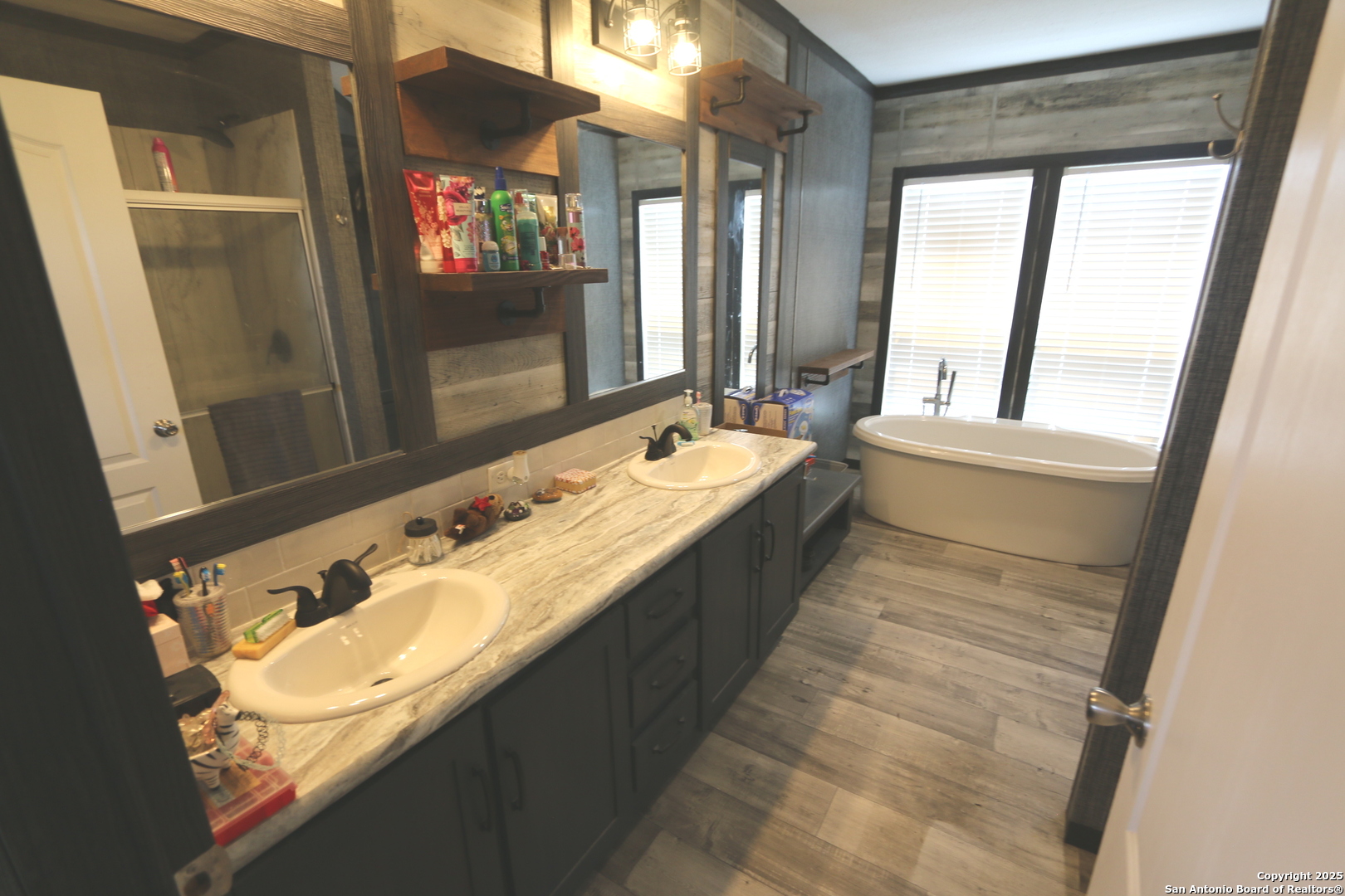7510 Pittman Road Adkins, TX 78101 - Photo 25 of 42 a bathroom with a double vanity sink and a large mirror