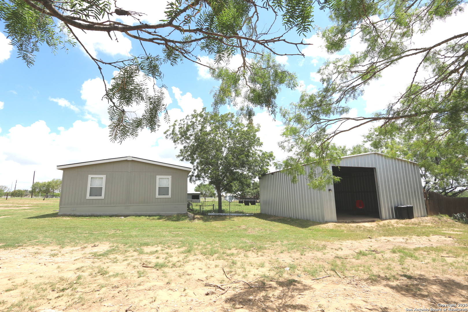 7510 Pittman Road Adkins, TX 78101 - Photo 4 of 42 a view of a house with a yard and garage