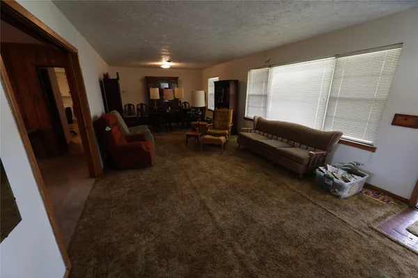 a view of a livingroom with furniture and a window