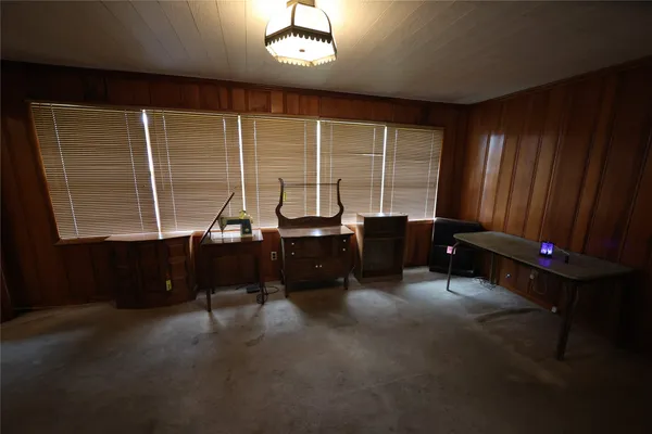 a view of a livingroom with furniture and a window
