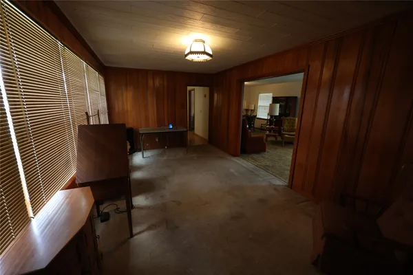 a view of a room with wooden floor and furniture