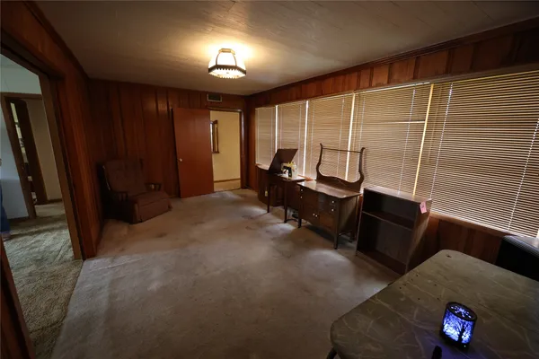 a living room with furniture rug and wooden floor